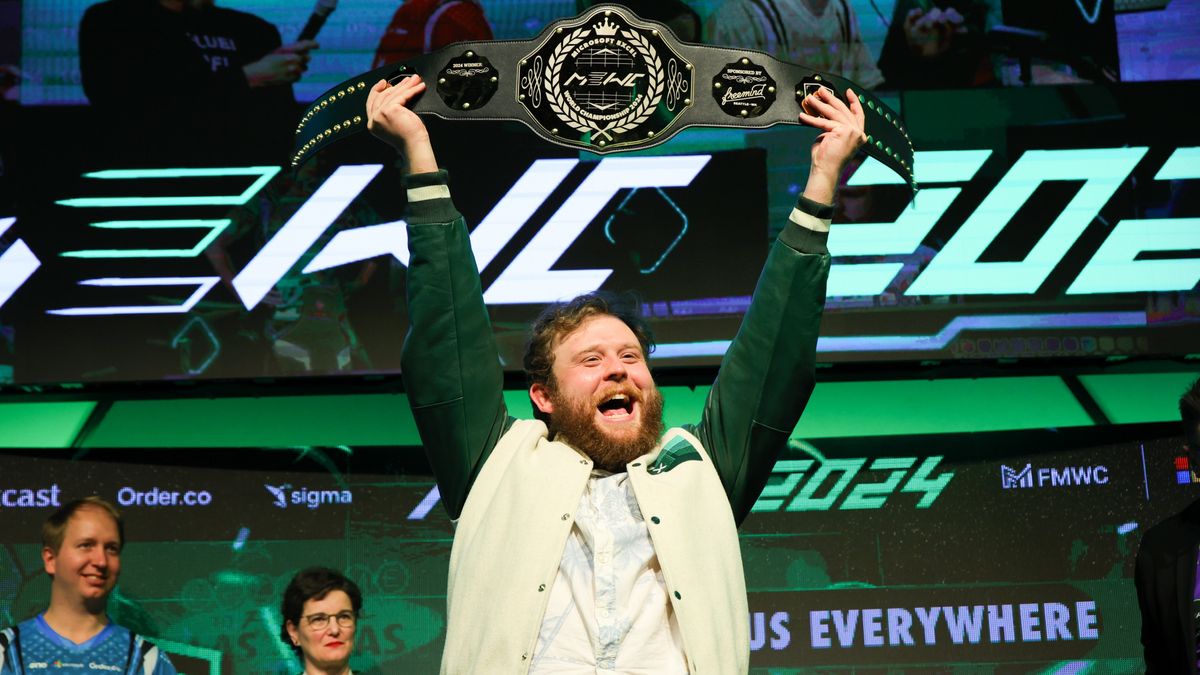 Michael Jarman holds his Excel championship belt aloft.